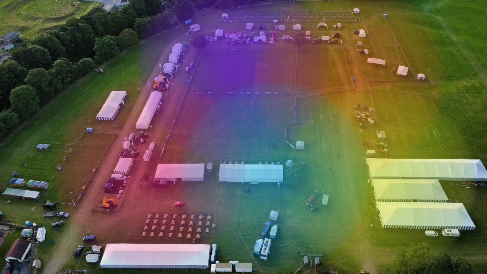 Aerial photo of a show field with marquees and parking, overlaid with coloured WiFi coverage